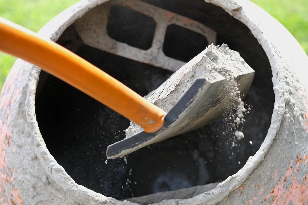 Construction,Site.,Adding,Lime,,Sand,And,Stones,To,Rotating,Cement