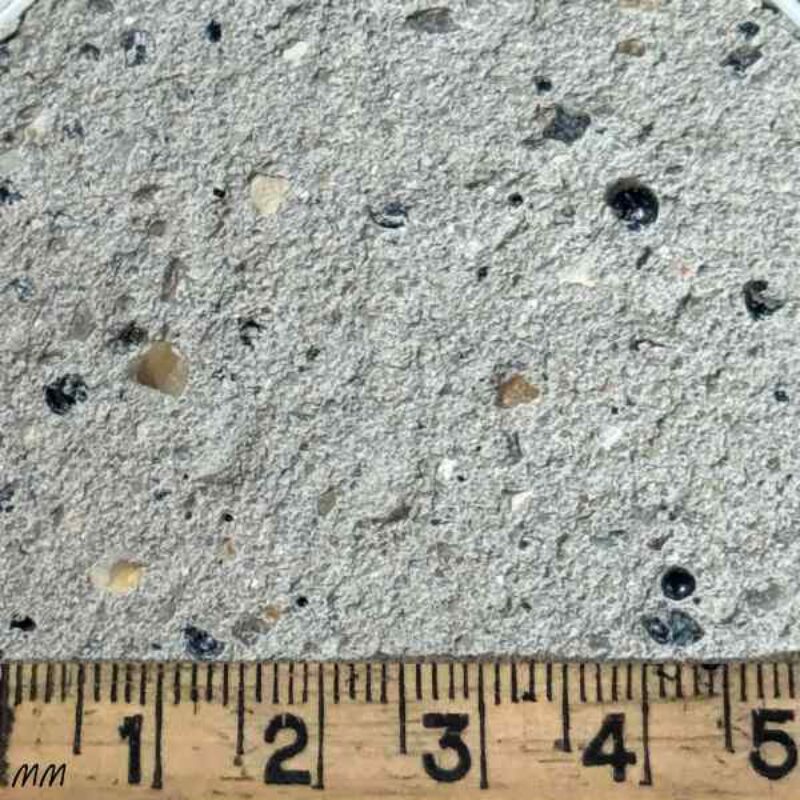 Close-up of W56 Fine Lias Black Fleck Lime Putty Mortar with ruler showing fine texture and black flecks